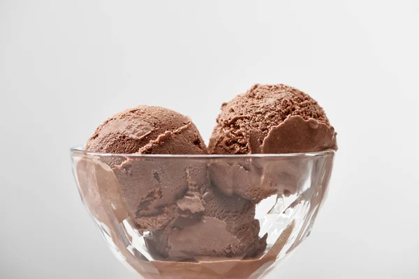 Close up view of delicious chocolate ice cream in glass bowl isolated on grey — Stock Photo