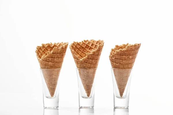 Fresh crispy sweet waffle cones isolated on white — Stock Photo