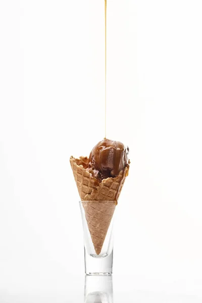 Delicious sweet ice cream in crispy waffle cone with dripping chocolate isolated on white — Stock Photo