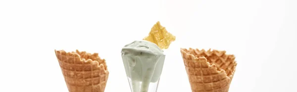 Fresh crispy sweet waffle cones and pistachio ice cream isolated on white, panoramic shot — Stock Photo