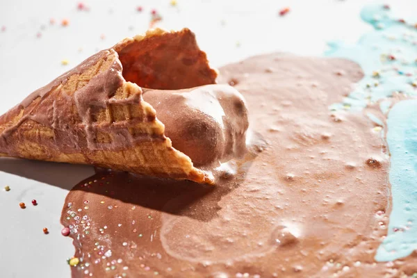 Близкий вид на вкусное растопленное шоколадное мороженое в вафельном конусе — стоковое фото