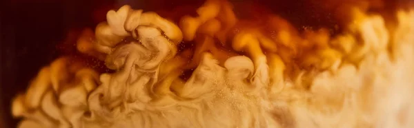 Close up view of coffee mixing with milk in glass, panoramic shot — Stock Photo