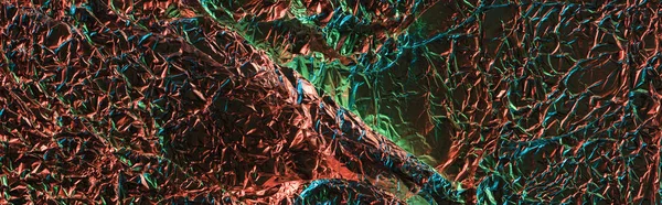 Panoramic shot of foil with colorful lighting reflection — Stock Photo