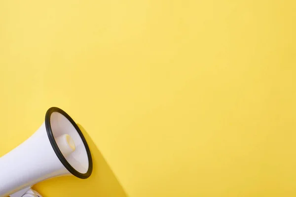 Top view of loudspeaker on yellow background with copy space — Stock Photo
