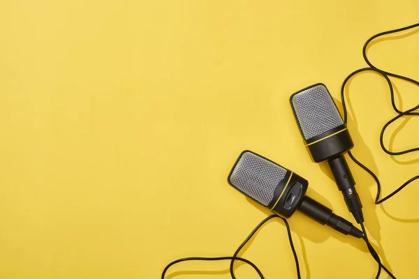 Top view of microphones on bright and colorful background with copy space — Stock Photo