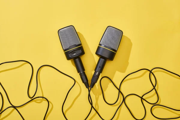 Top view of microphones on bright and colorful background with copy space — Stock Photo