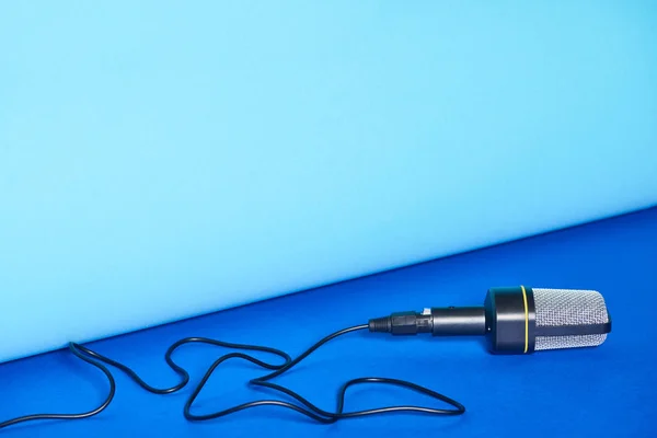 Black microphone on bright and colorful background with copy space — Stock Photo