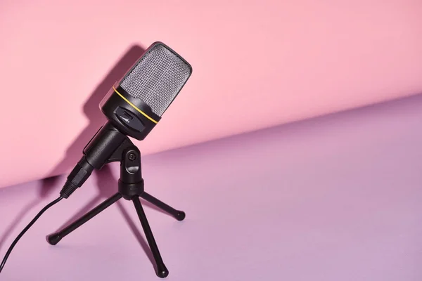 Black microphone on bright and colorful background with copy space — Stock Photo