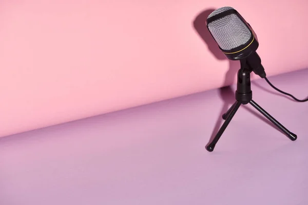 Black microphone on bright and colorful background with copy space — Stock Photo