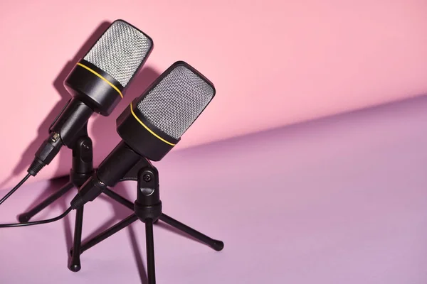 Black microphones on bright and colorful background with copy space — Stock Photo