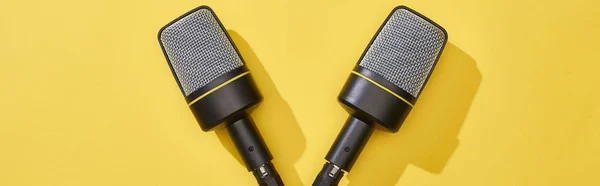 Panoramic shot of microphones on bright and colorful background — Stock Photo
