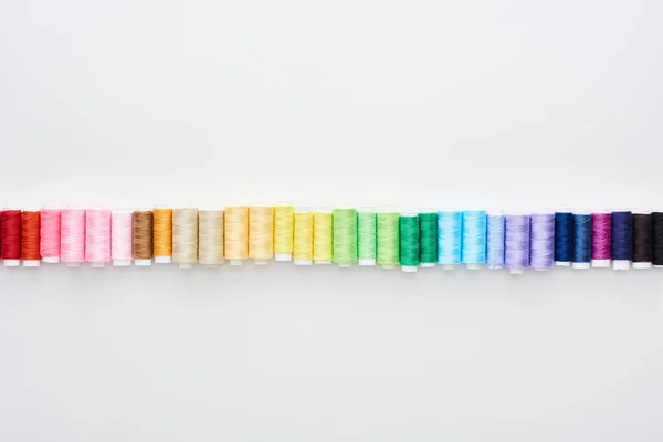 Top view of bright and colorful threads on white background — Stock Photo