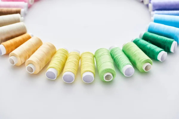 Flat lay with bright and colorful threads on white background — Stock Photo