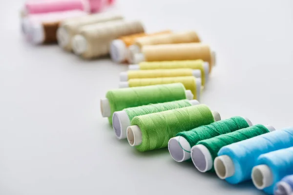 Selective focus of bright and colorful threads on white background — Stock Photo