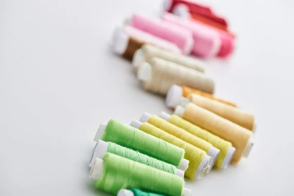 Selective focus of bright and colorful threads on white background — Stock Photo