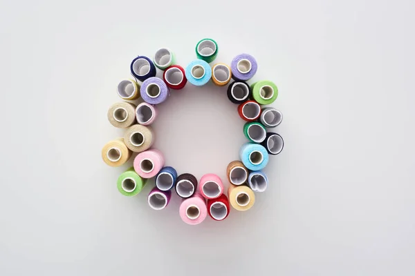 Top view of bright and colorful threads on white background — Stock Photo