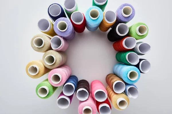 Top view of bright and colorful threads on white background — Stock Photo