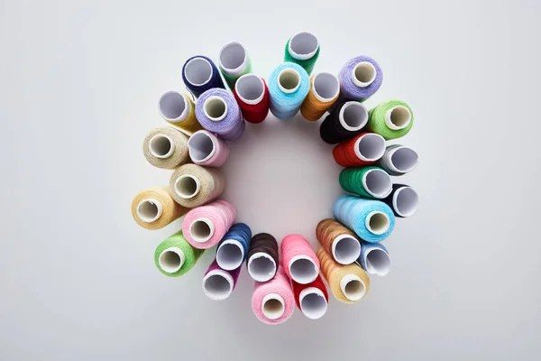 Top view of bright and colorful threads on white background — Stock Photo