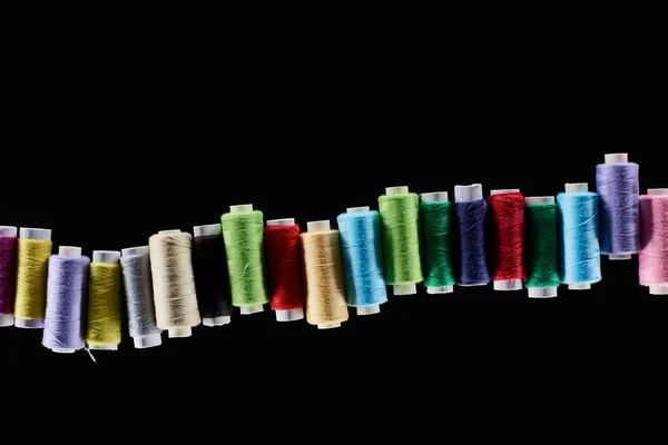 Top view of bright and colorful threads isolated on black — Stock Photo