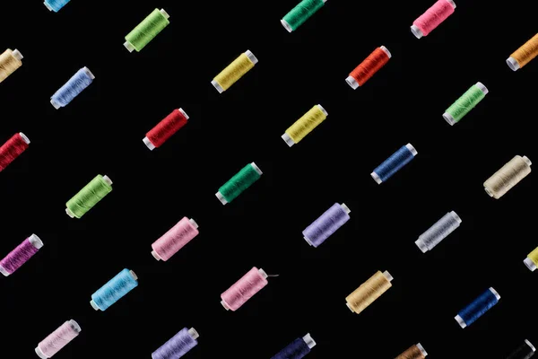 Top view of bright and colorful threads isolated on black — Stock Photo