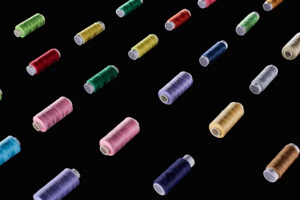 Сині, коричневі, сірі, зелені, рожеві, фіолетові, червоні, жовті нитки ізольовані на чорному — стокове фото