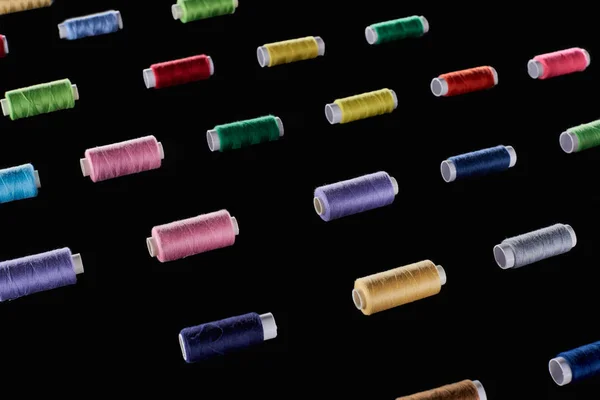 Blue, gray, green, pink, purple, red, yellow threads isolated on black — Stock Photo