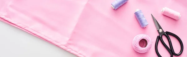 Panoramic shot of fabric, knitting yarn ball, scissors and threads on white background — Stock Photo