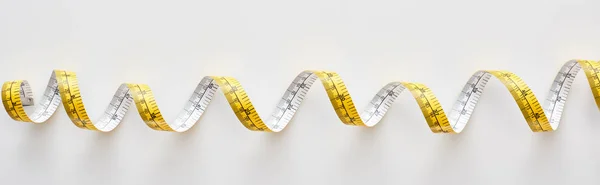 Panoramic shot of colorful measuring tape on white background — Stock Photo