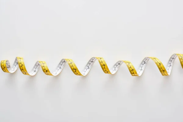 Top view of colorful measuring tape on white background — Stock Photo