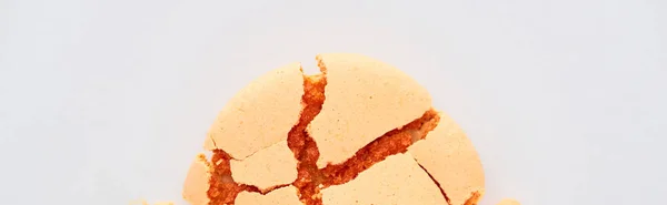 Close up view of delicious orange smashed French macaroon isolated on white, panoramic shot — Stock Photo