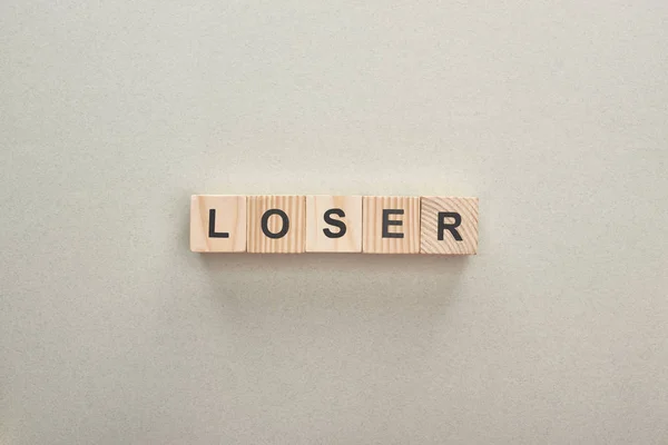 Top view of wooden blocks with loser word on grey background, bullying concept — Stock Photo