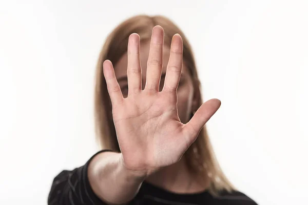 Selective focus of  female victim of bullying showing stop sign isolated on white — Stock Photo