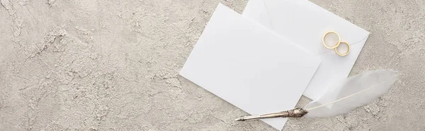 Panoramic shot of empty card and envelope near quill pen on textured surface — Stock Photo
