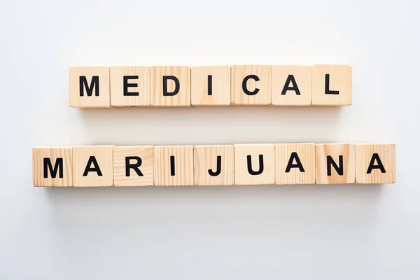 Top view of wooden blocks with medical marijuana words on white background — Stock Photo