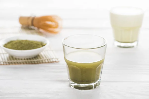 Selective focus of traditional green matcha tea on white table — Stock Photo
