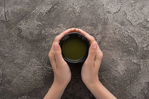 Top view of woman holding matcha matcha tea in hands — Stock Photo