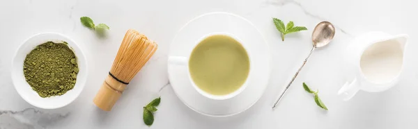 Flat lay with green matcha tea and milk on white table — Stock Photo