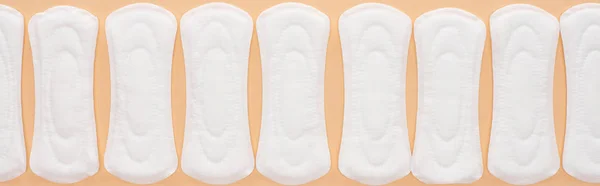 Flat lay with white cotton sanitary towels isolated on beige, panoramic shot — Stock Photo