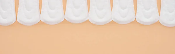 Flat lay with white cotton sanitary napkins isolated on beige, panoramic shot — Stock Photo