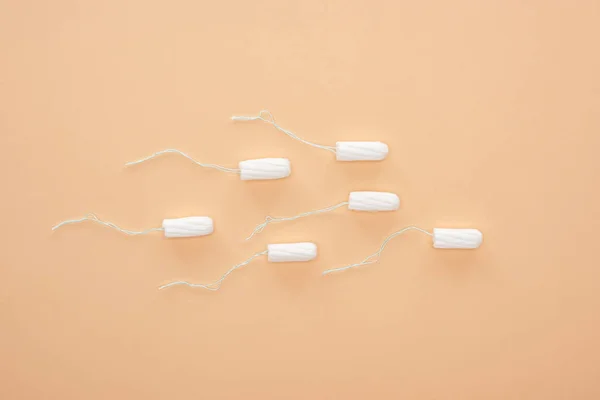 Top view of white cotton tampons isolated on beige — Stock Photo