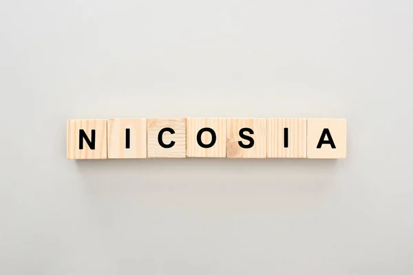 Top view of wooden blocks with Nicosia lettering on white background — Stock Photo