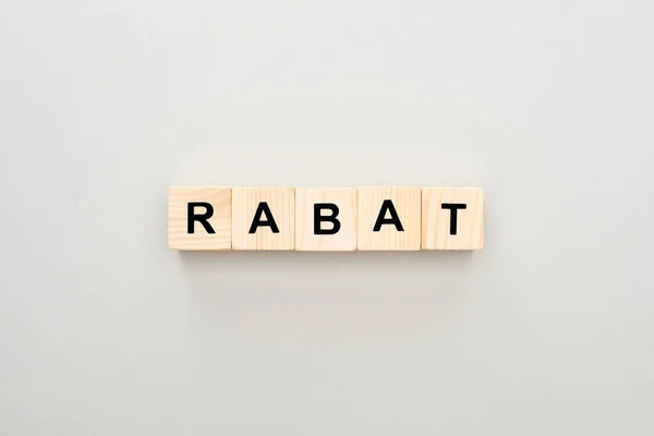 Top view of wooden blocks with Rabat lettering on white background — Stock Photo