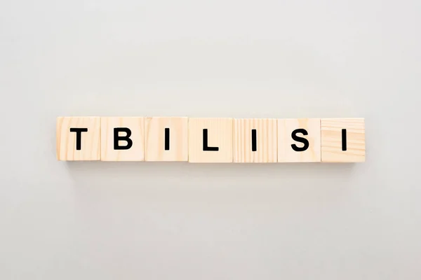 Top view of wooden blocks with Tbilisi lettering on white background — Stock Photo