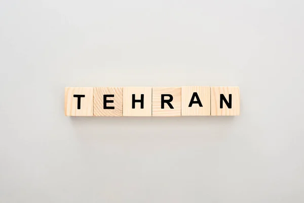 Top view of wooden blocks with Tehran lettering on white background — Stock Photo