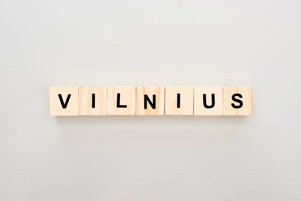 Top view of wooden blocks with Vilnius lettering on white background — Stock Photo