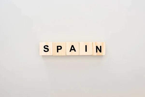 Top view of wooden blocks with Spain lettering on white background — Stock Photo