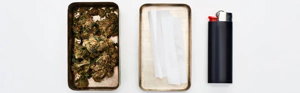 Flat lay with metal box with marijuana buds and rolling paper near lighter, panoramic shot — Stock Photo