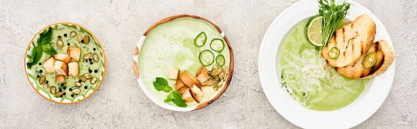 Flat lay with delicious creamy green soup served with croutons, panoramic shot — Stock Photo