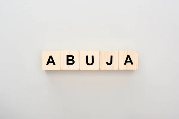 Vue de dessus des blocs de bois avec lettrage Abuja sur fond gris — Photo de stock