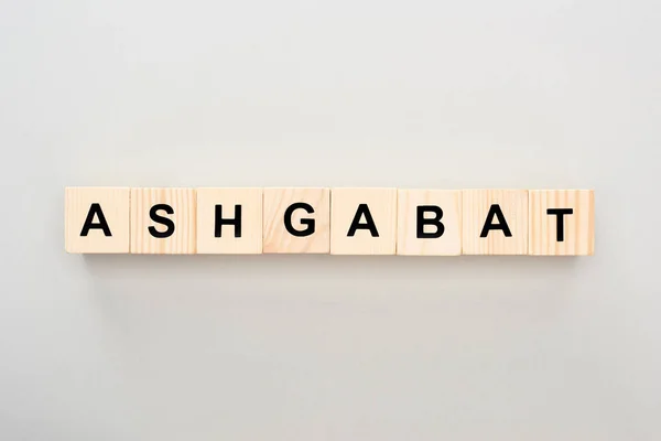 Top view of wooden blocks with Ashgabat lettering on grey background — Stock Photo